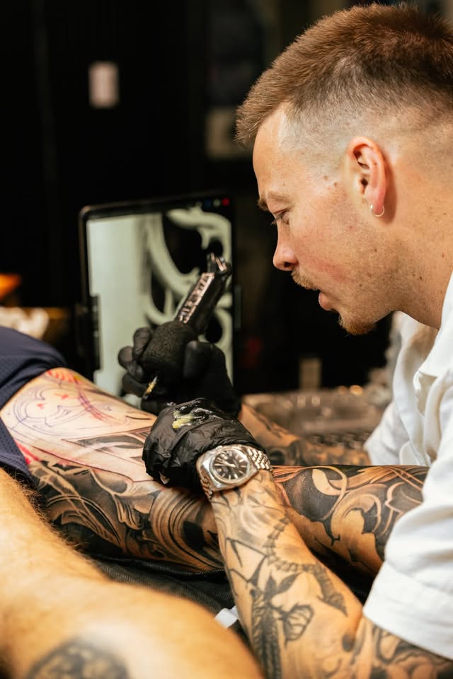 Trevor McQuade close-up during a tattoo session