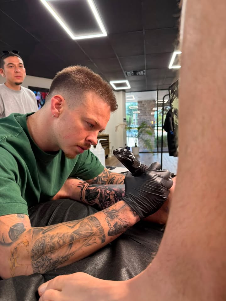 Trevor working on an arm tattoo